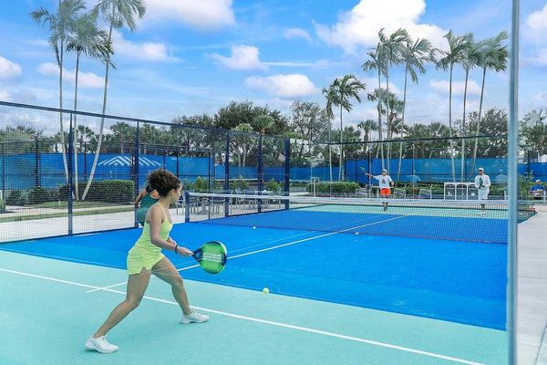 Pickleball player on the club's blue courts